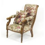 A walnut framed open armchair with reeded and turned legs and floral linen upholstery