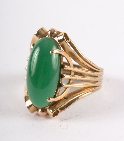 A chrysoprase ring, the oval stone in a stylised 14ct yellow gold setting,