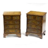 A pair of burr walnut bedside cabinets, each fitted two short and three long drawers, 46cm wide,