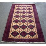 A North West Persian Rug, three rows of seven medallions on a cream ground within a guard stripe,