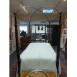 A 19th Century campaign bed, the foot columns with leaf carved capitals above twist turned,