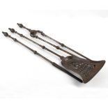 A set of three burnished steel fire irons,