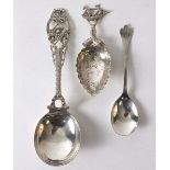 A silver caddy spoon, import marks T H, London 1901, with ship and entwined dolphin handle,