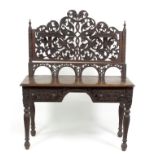 An Anglo-Ceylonese side table, the raised pierced scrolling back with two small shelves,