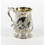 A George III silver mug, London 1767, of baluster form with later embossed decoration, initialled,