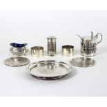 A silver mustard pot, Sheffield 1894, a small silver circular stand, two napkin rings, two coasters,