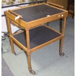 An oak two-tier slate based tea trolley, fitted a drawer on octagonal supports,