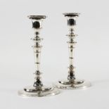 A pair of Sheffield plated candlesticks of oval form