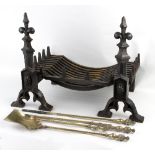 A basket grate, the fire dogs with poppy finials,