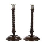 A good pair of George III mahogany candlesticks, twist turned and leaf carved,