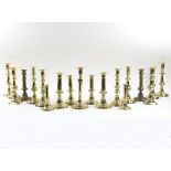 Eight pairs of 19th Century brass candlesticks, various forms, 26cm high and smaller,