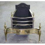 A Regency style fire grate, the serpentine front in burnished steel with brass finials and apron,