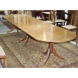 A George III style triple-pedestal dining table with rounded ends,