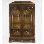 A Danish mahogany display cabinet, circa 1900, enclosed by glazed panel doors,