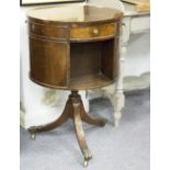 A mahogany reproduction bookcase of drum shape on a tripod base,