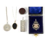 A silver fob set a bloodstone and carnelian, a gold mounted pendant, a silver 1887 pendant,