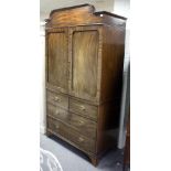 A Regency mahogany linen press, fitted sliding trays and two long and two short drawers beneath,