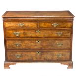 A George II walnut and feather-banded chest of two short over three long drawers, on bracket feet,