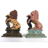 A pair of painted cast iron door stops, each cast as a rampant lion on a plinth,