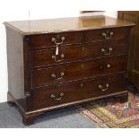 A George II mahogany chest of two short over three long drawers on bracket feet,