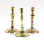 A pair of mid 18th Century brass candlesticks with moulded baluster stems, 20.