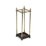 A brass stick stand of four divisions with finials to the corners,