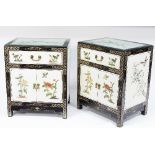 A pair of Oriental painted bedside tables, each fitted a drawer above panelled doors,