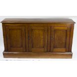 A Victorian mahogany side cabinet fitted three cupboard doors,