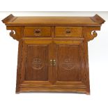 A 20th Century Chinese altar type table fitted two drawers above panelled doors,