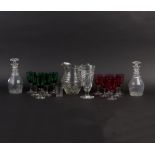 A pair of cut glass decanters, 22cm high, a cut glass jug, six ruby coloured glasses,