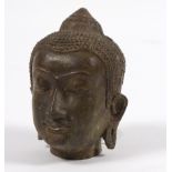 A bronze head of a Buddha,