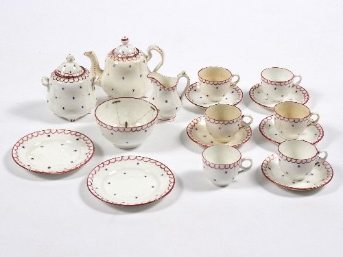 A child's porcelain tea set decorated blue and puce to a white ground