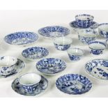 A collection of Chinese blue and white tea bowls and saucers, mostly early 18th Century,