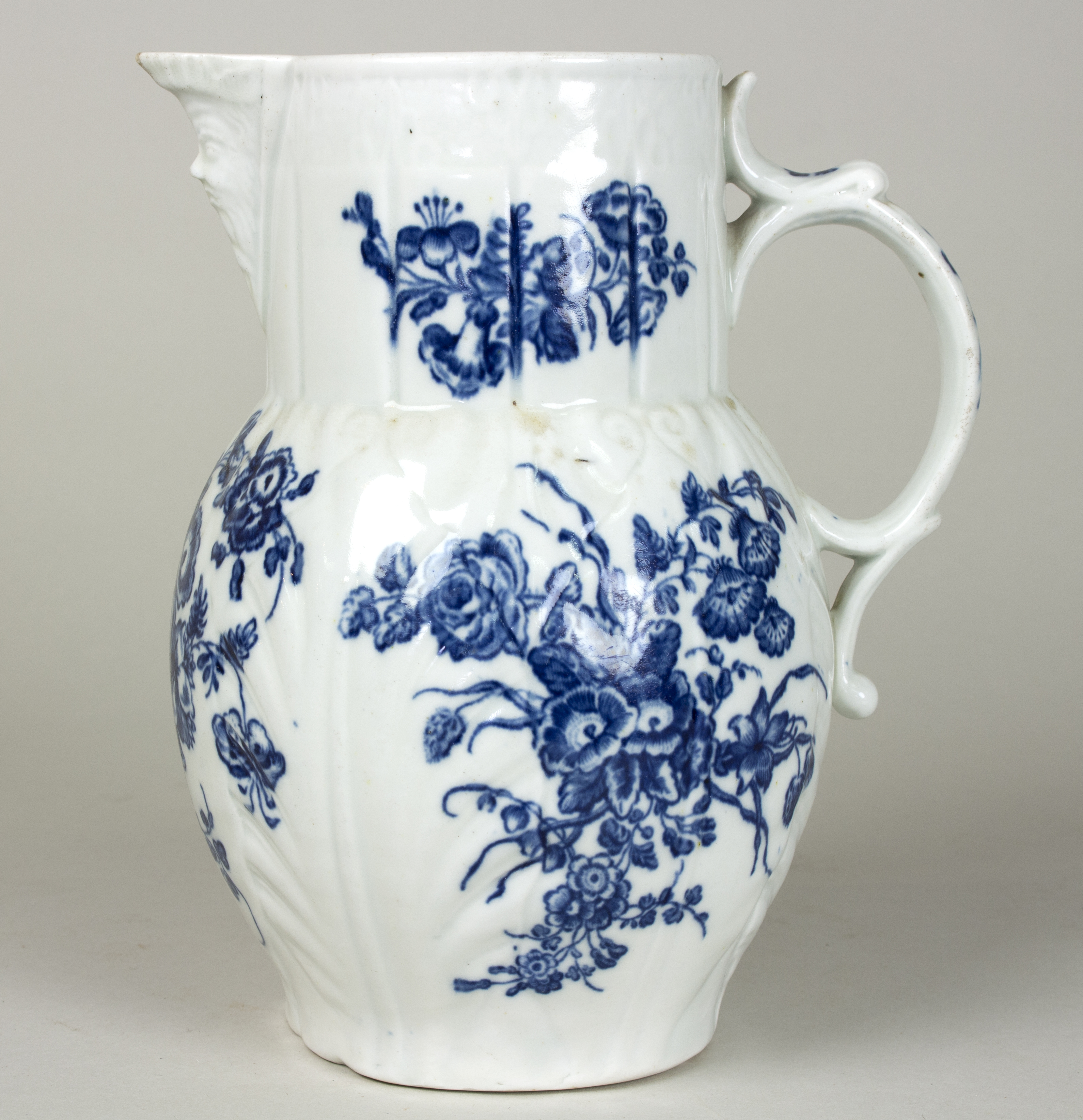 A Worcester blue and white cabbage-leaf moulded jug, circa 1780, printed with a Chinese fisherman,