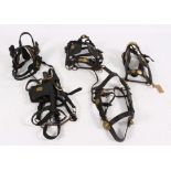 Harness: A quantity of heavy horse bridles with blinkers, one with brass mounts initialled L B/L,