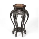 A Chinese hexagonal hardwood jardinière stand with pierced floral decoration, inset marble top,