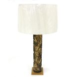 A table lamp, the column formed from a wallpaper printing roll with new shade,