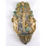 A 18th Century Italian polychrome majolica Holy water stoop, moulded with a crucifix,