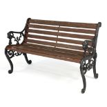 A garden bench with cast iron ends, the arms with lion mask terminals,