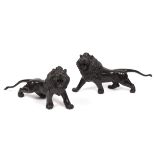 A pair of Japanese bronze roaring lions, Meiji period, with beaded eyes, signed Seikoku,