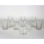 A group of mostly etched glassware comprising three wine glasses, 13cm high, two Champagne coupes,