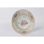 A Meissen reticulated cabinet plate, circa 1870, painted flowers,
