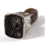 An intaglio carved desk seal, possibly 17th Century, the matrix depicting a youth in profile,