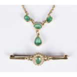 An emerald necklace, the four stones in rub-over settings to a rope twist 9ct gold chain,