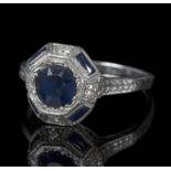 An Art Deco diamond and sapphire dress ring, the central sapphire approximately 0.