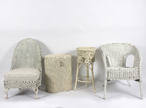 A Lloyd Loom 'Lusty' nursing chair, painted in white, a laundry basket,