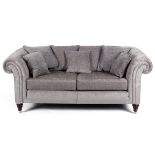 A Chesterfield style sofa upholstered in dove grey velvet,