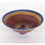 Mary Rich (British, born 1940)/Shallow footed porcelain bowl/decorated bands of blue, red and gold,