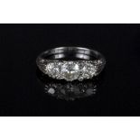 A diamond set dress ring, the central old cut stone approximately 0.