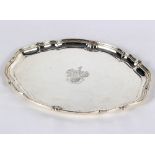 A silver tray, Elkington & Co, Birmingham 1923, of shaped oval form with armorial and motto,